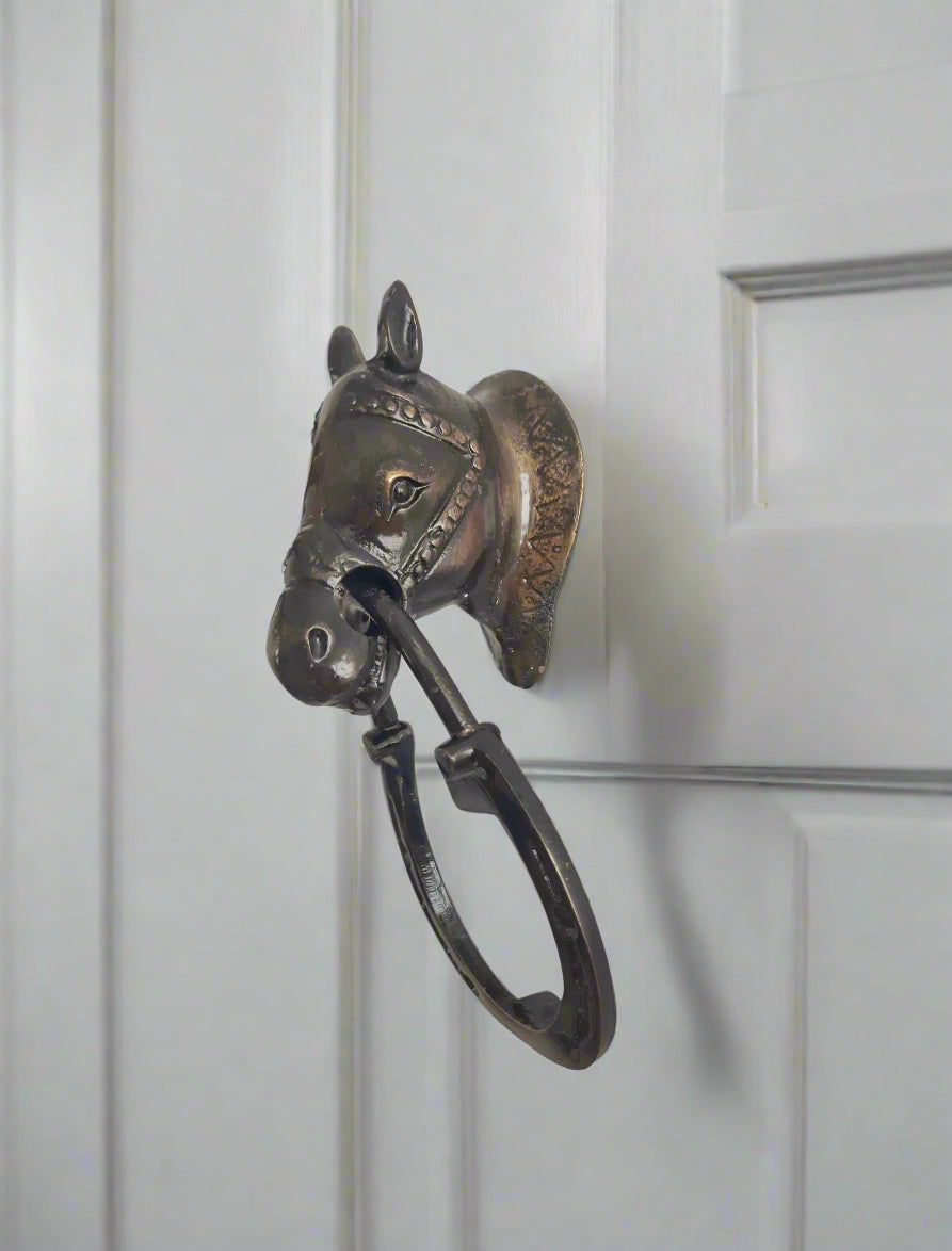 Antique door knocker on a white door