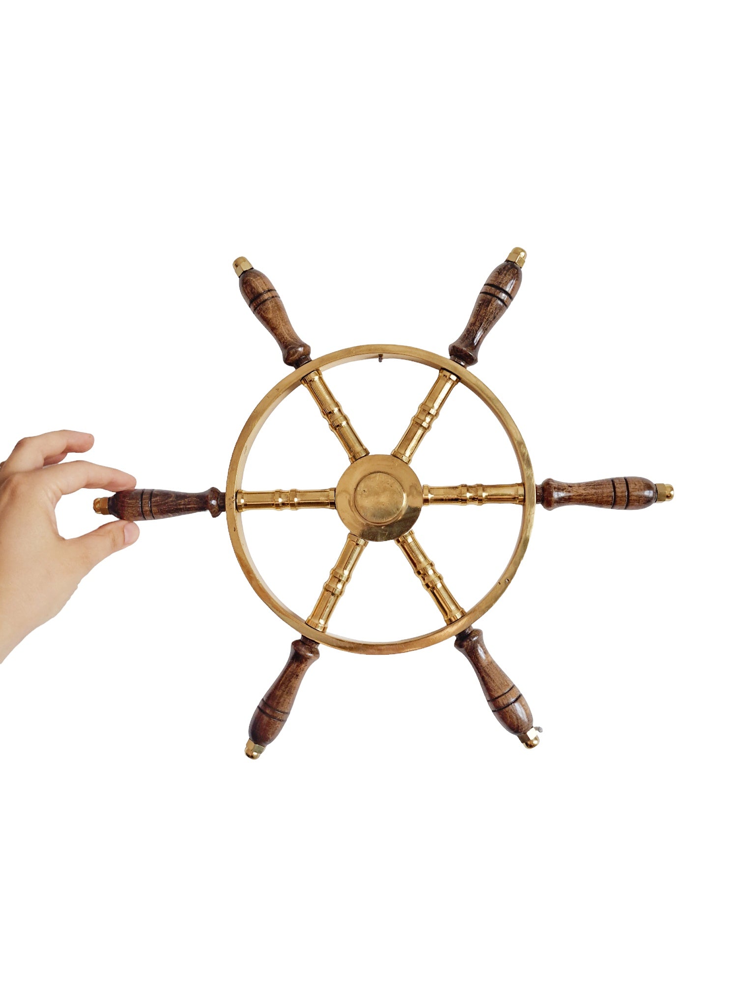 Wooden steering wheel with a hand holding it on a white background
