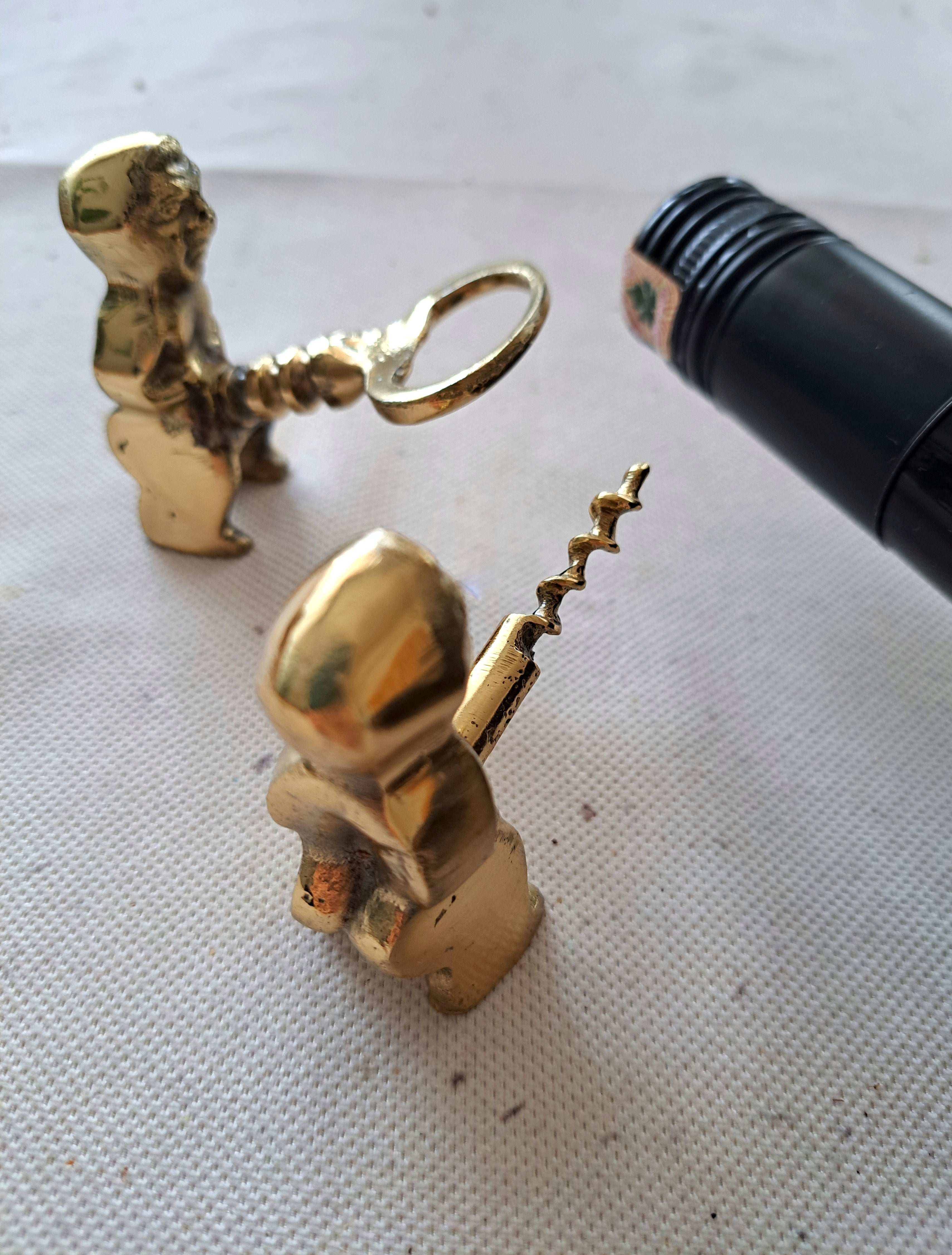 Brass corkscrew and bottle opener shaped like a fertility god figure