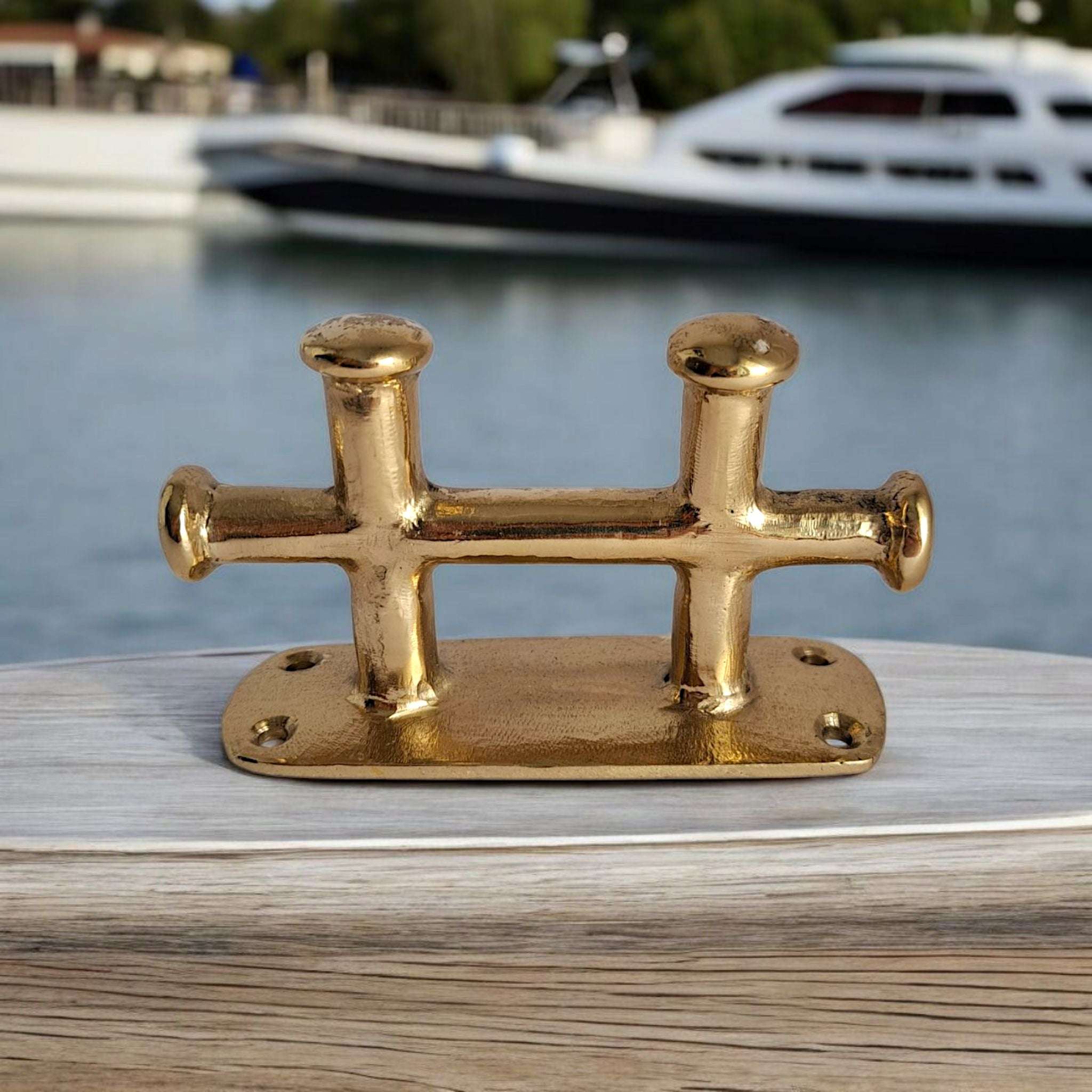 Solid brass boat tie fitting on wooden base