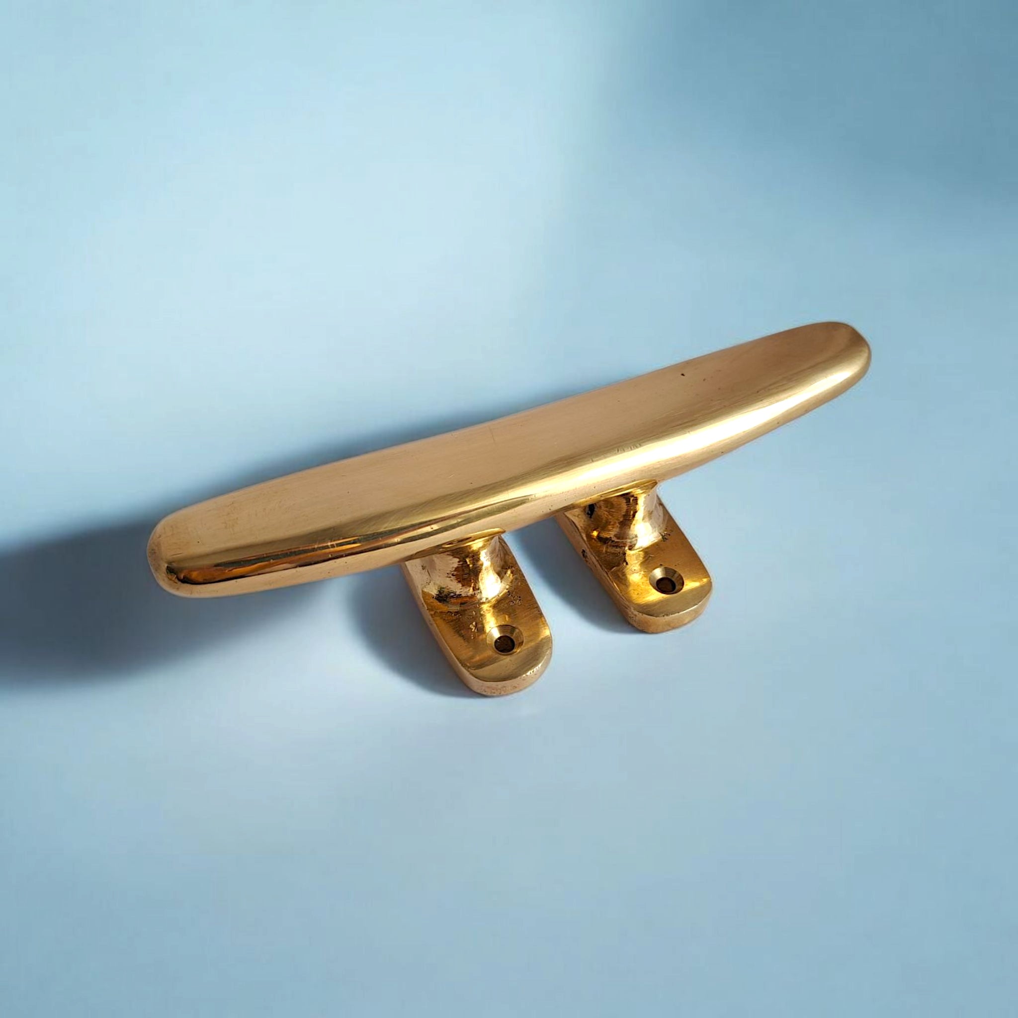 Close-up of solid brass cleat with two rope arms