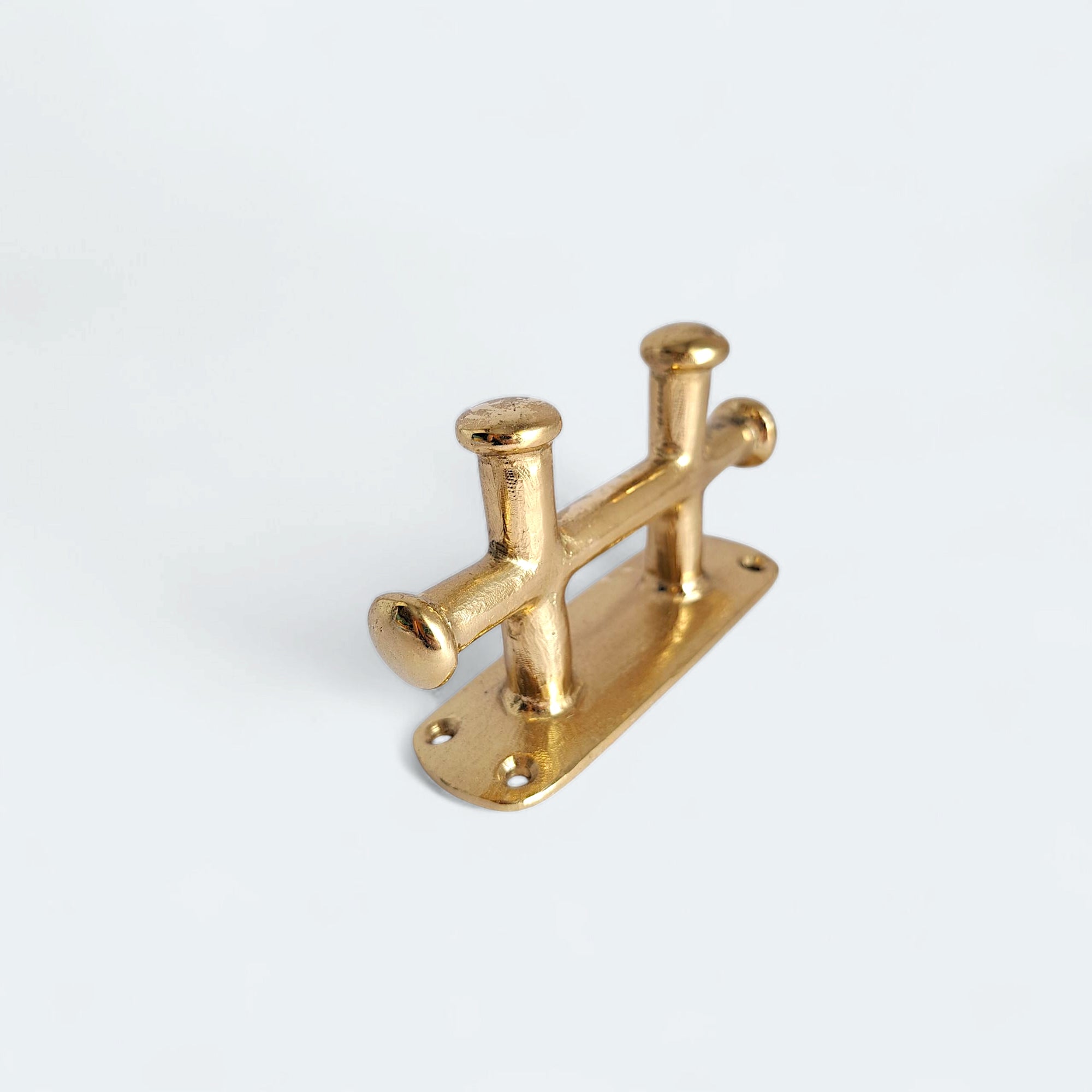 Nautical brass cleat with rustic finish and detail