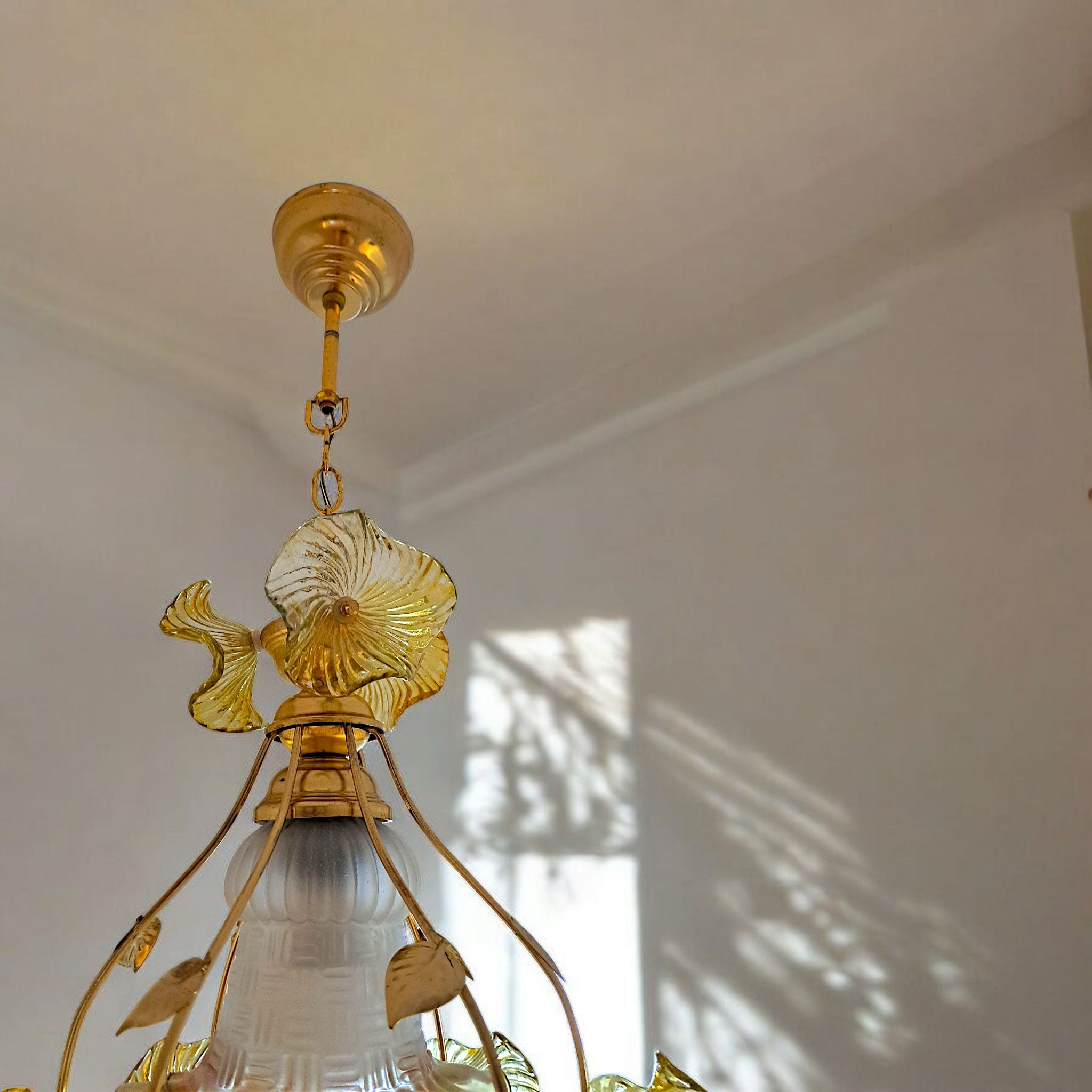 Gold-armed chandelier featuring yellow glass flower accents