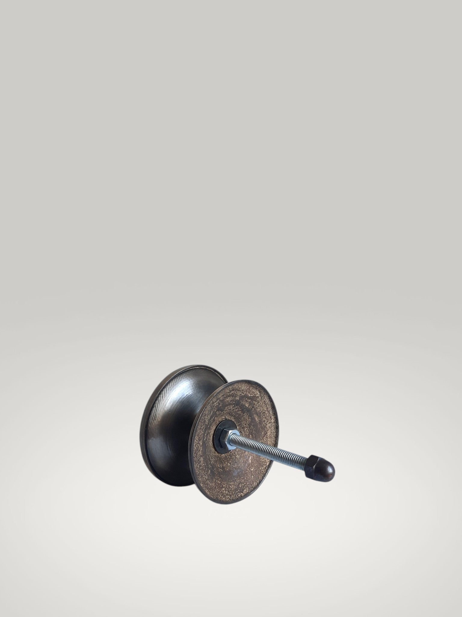 Metallic door handle on a light gray background