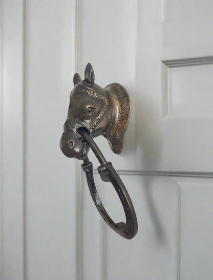Antique door knocker on a white door