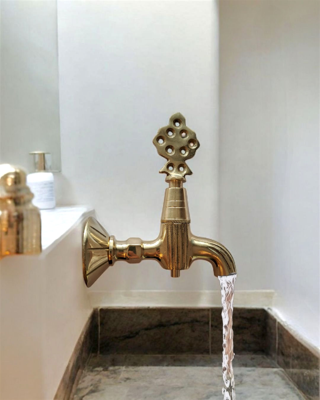 Traditional brass faucet with a golden antique finish
