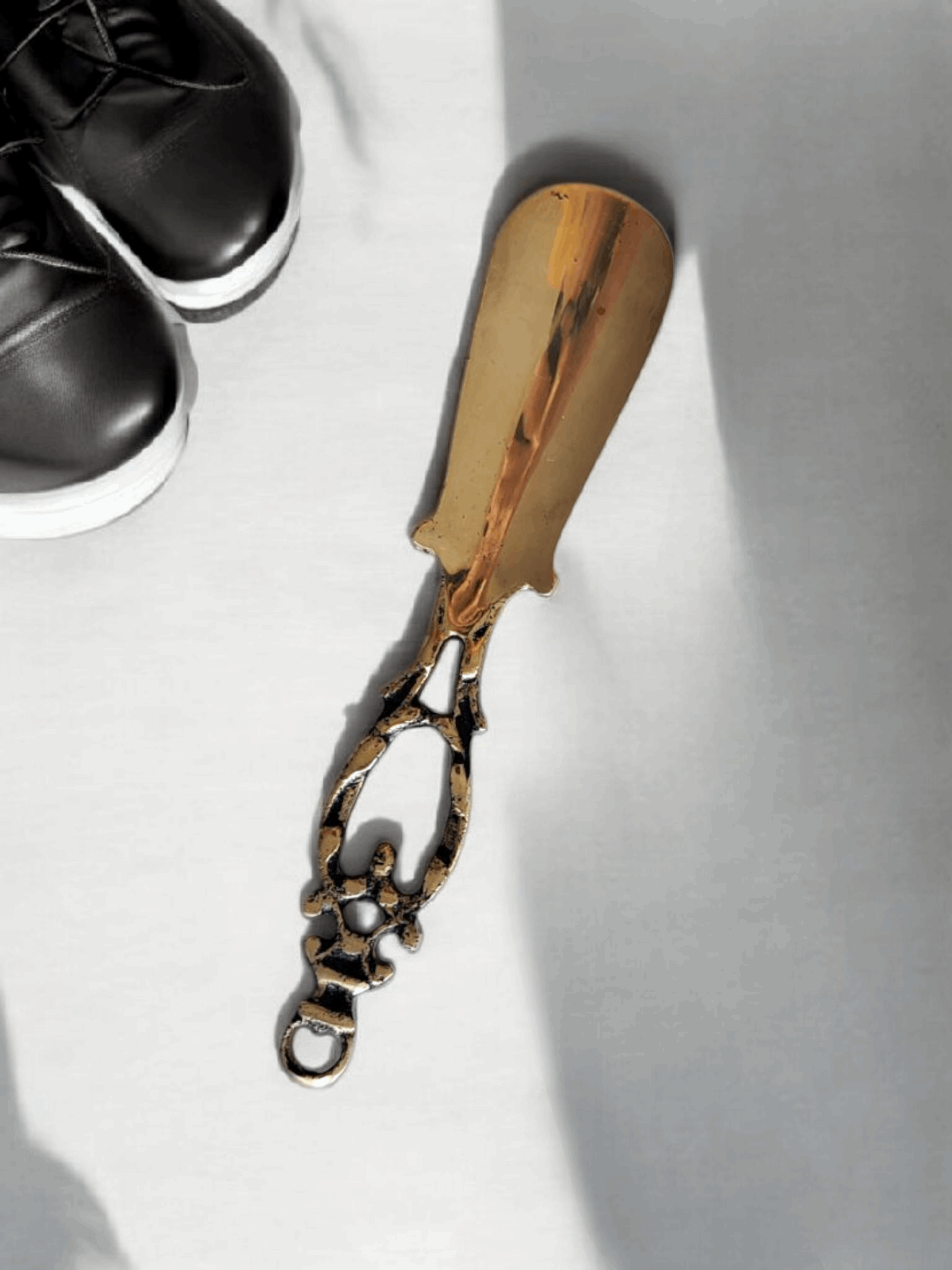 Classic shoe lifter with an intricate gold handle