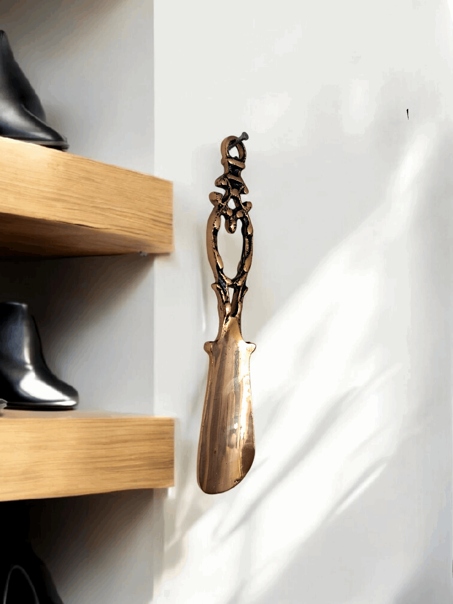 Small handcrafted brass shoe horn with a vintage gold finish