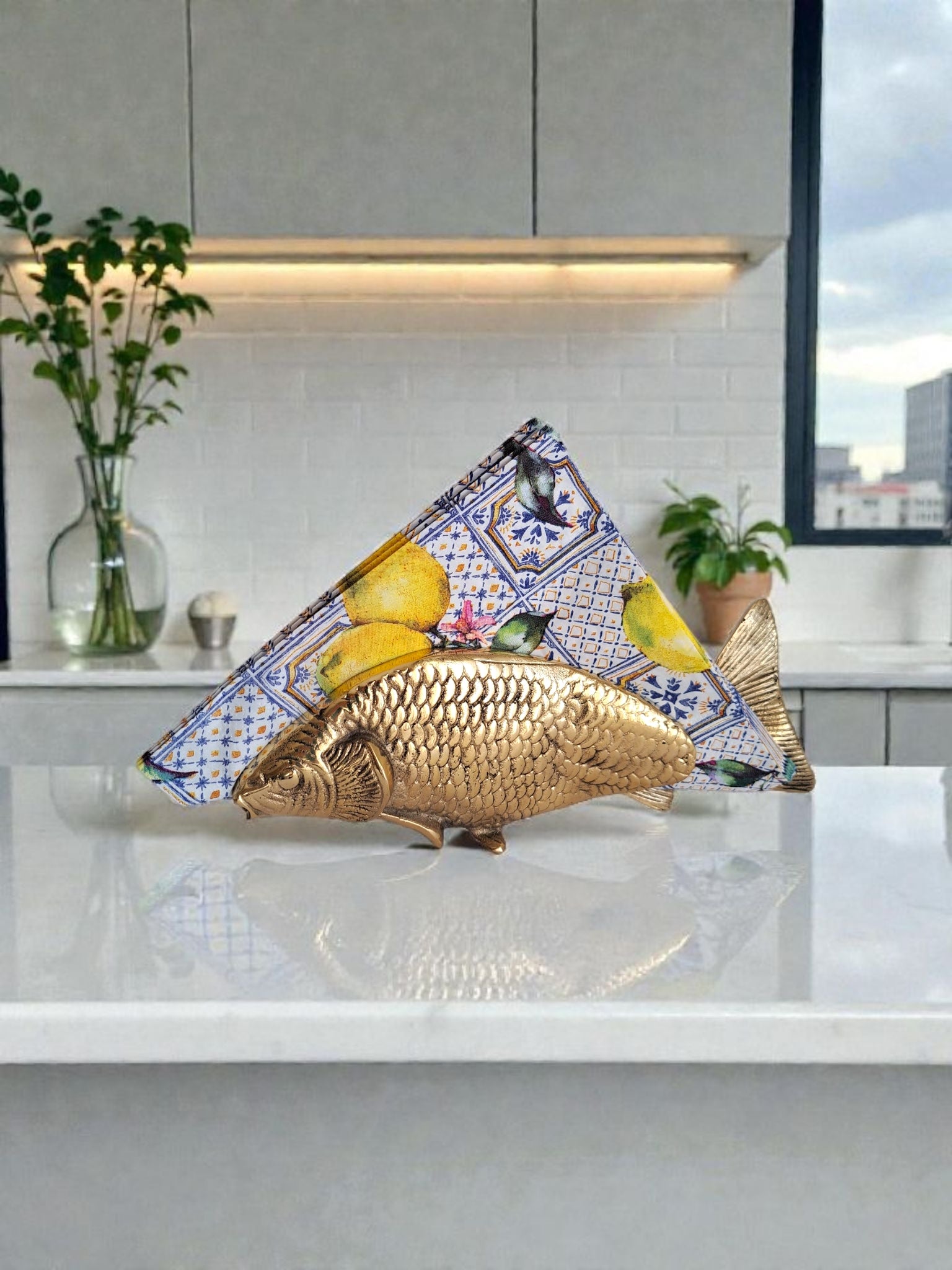 Decorative kitchen backsplash with a gold fish and lemons design in a modern kitchen.