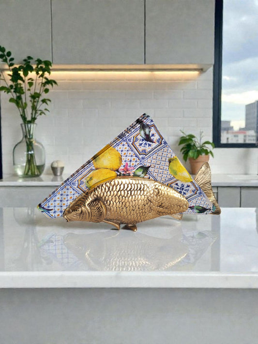 Decorative kitchen backsplash with a gold fish and lemons design in a modern kitchen.