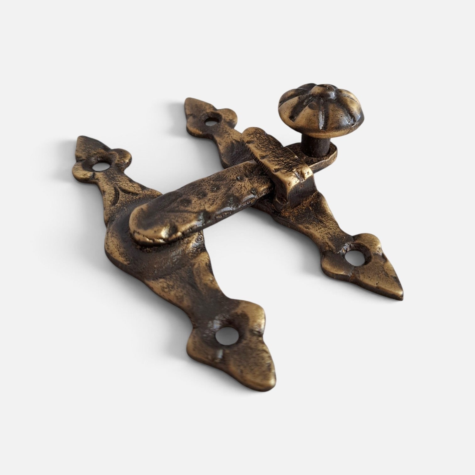 An antique-style bronze door hardware latch with a decorative knob, shown on a light gray background.