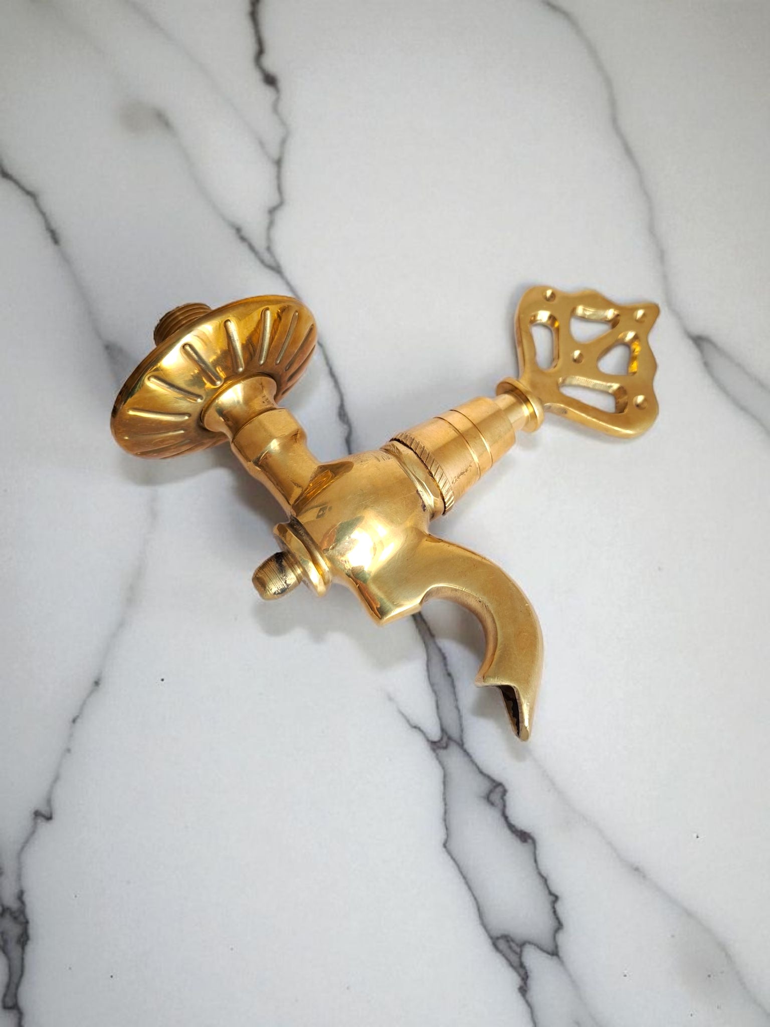 Gold faucet on a marble background
