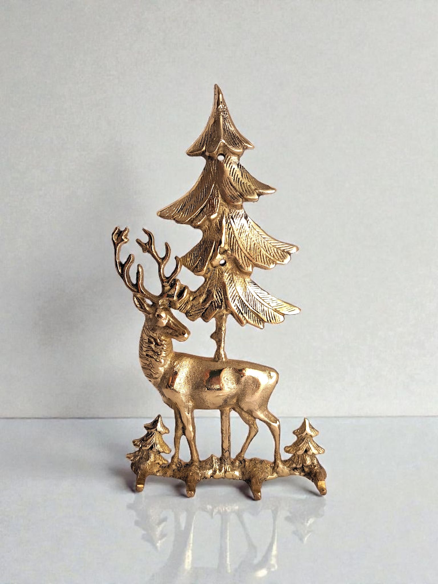 Gold deer and tree decorative piece on a white background