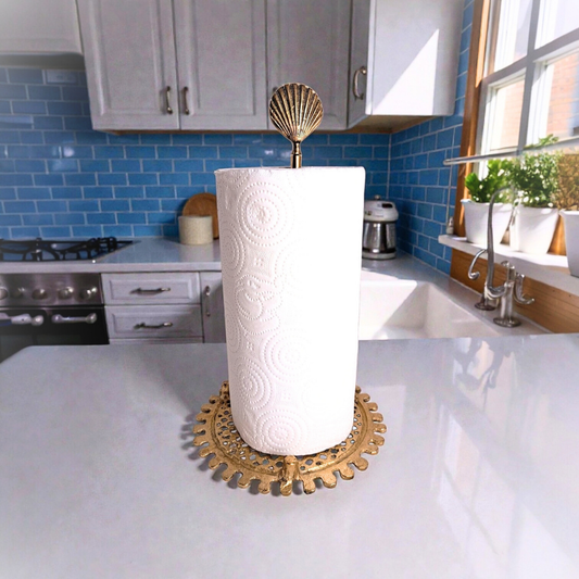 Decorative paper towel holder with a shell design on a kitchen counter.