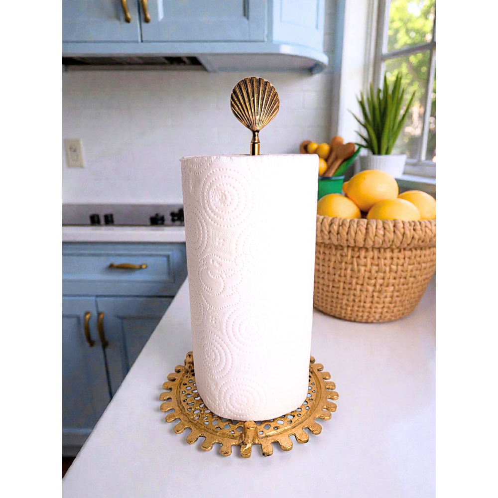 Decorative paper towel holder with a shell design on a kitchen counter.